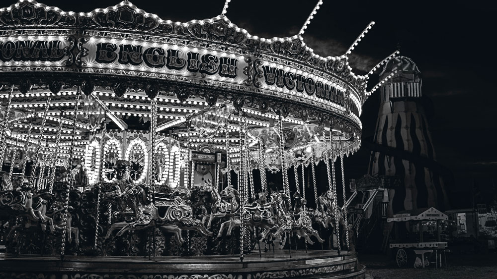 Fair grounds with an old style English Victorian carousel or merry-go-round, signifying that you should provide the answers necessary in your plans.