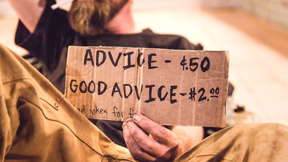 This man's sign points out that good advice costs more. Cheap architectural plans may cost less, but you get what you pay for.