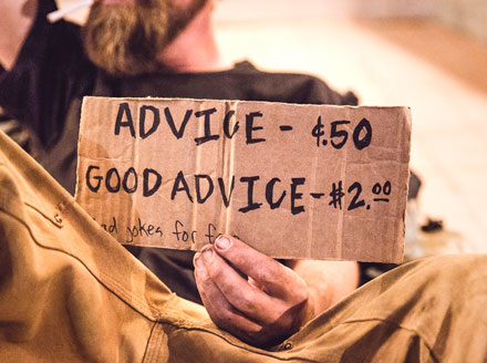This man's sign points out that good advice costs more. Cheap architectural plans may cost less, but you get what you pay for.