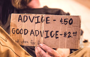 This man's sign points out that good advice costs more. Cheap architectural plans may cost less, but you get what you pay for.