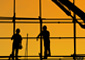 Silhouette of two construction workers on scaffolding, signifying the current condition of the architectural and construction industries.