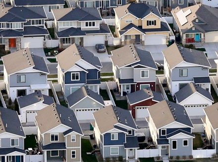 An entire neighborhood of tract homes that all look alike, signifying the lack of architectural creativity in planned communities