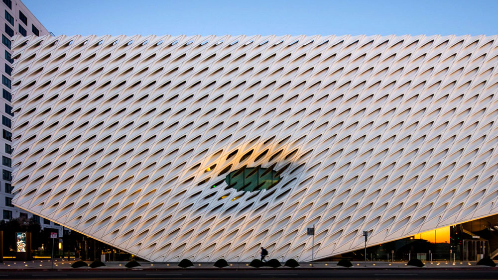 Evening photo of The Broad, contemporary art museum in Los Angeles, with a sculpted glass fiber reinforced concrete exterior