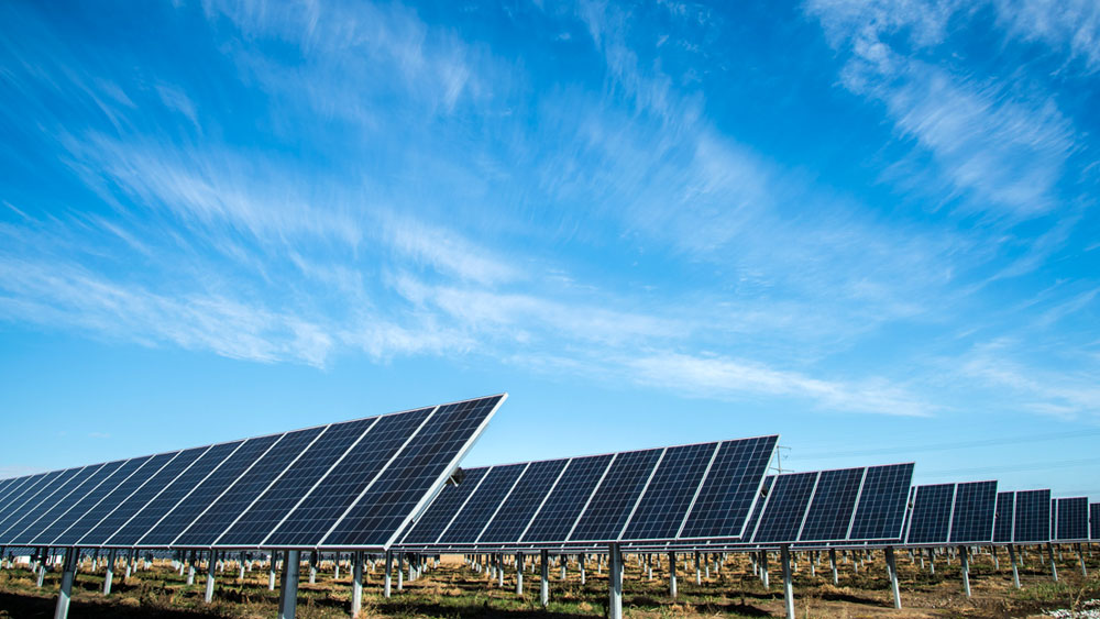 An array of solar panels at a Lincoln Electric facility in Lincoln, Nebraska under a blue sky with wispy white clouds