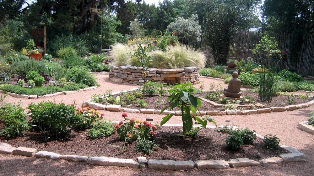 Asian-influenced xeriscape with stone Buddha, bamboo, ornamental grasses and native green vegetation