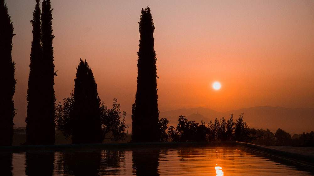 Bright orange Texas sunset reflected on water, capturing the natural beauty of the sunlight and surroundings on a lake-adjacent lot