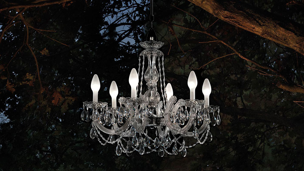 A single tier crystal-looking chandelier made for the outdoors in clear glass with 12 LED lights from Masiero.