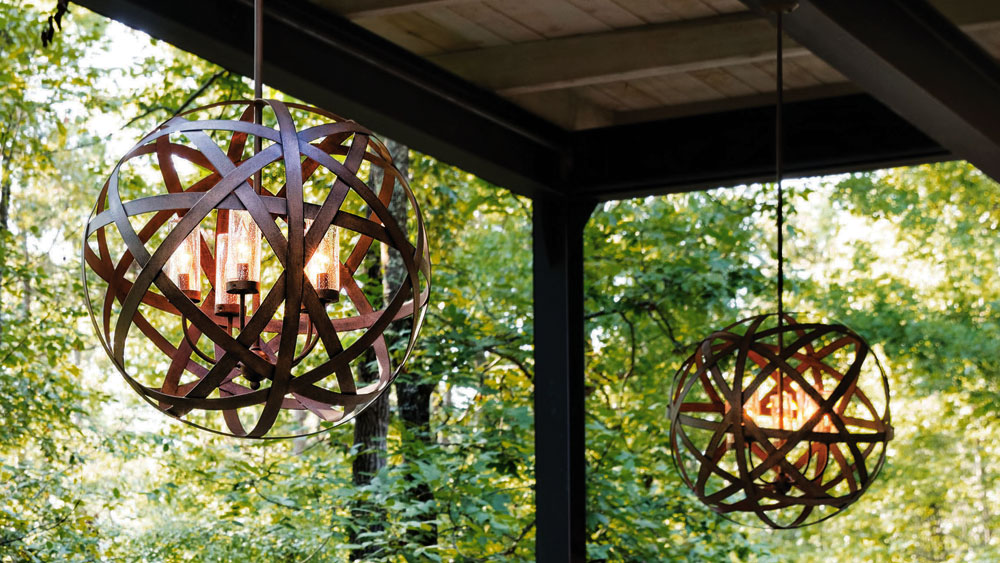 Hinkley outdoor chandelier made of flat iron rods formed into an orb, surrounding vintage bulbs in hurricane glass