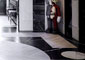 Sunlight floods through an iron double door in Drake's foyer into the custom designed Nero Marquina and Escarpment White marble inlaid floor.