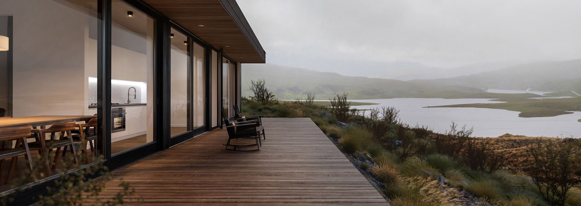 Organic modern home with ipe wood deck overlooking a lake with rolling hills in the background